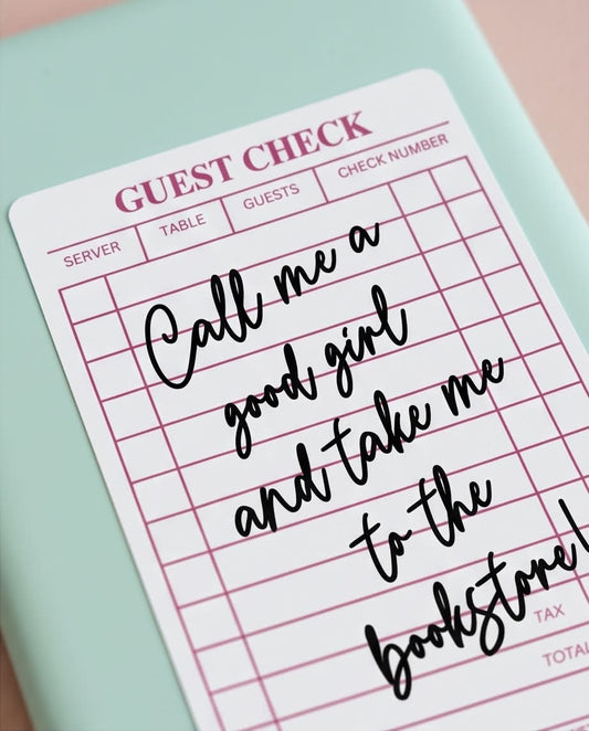 close up of guest check sticker that says "call me a good girl and take me to the bookstore"