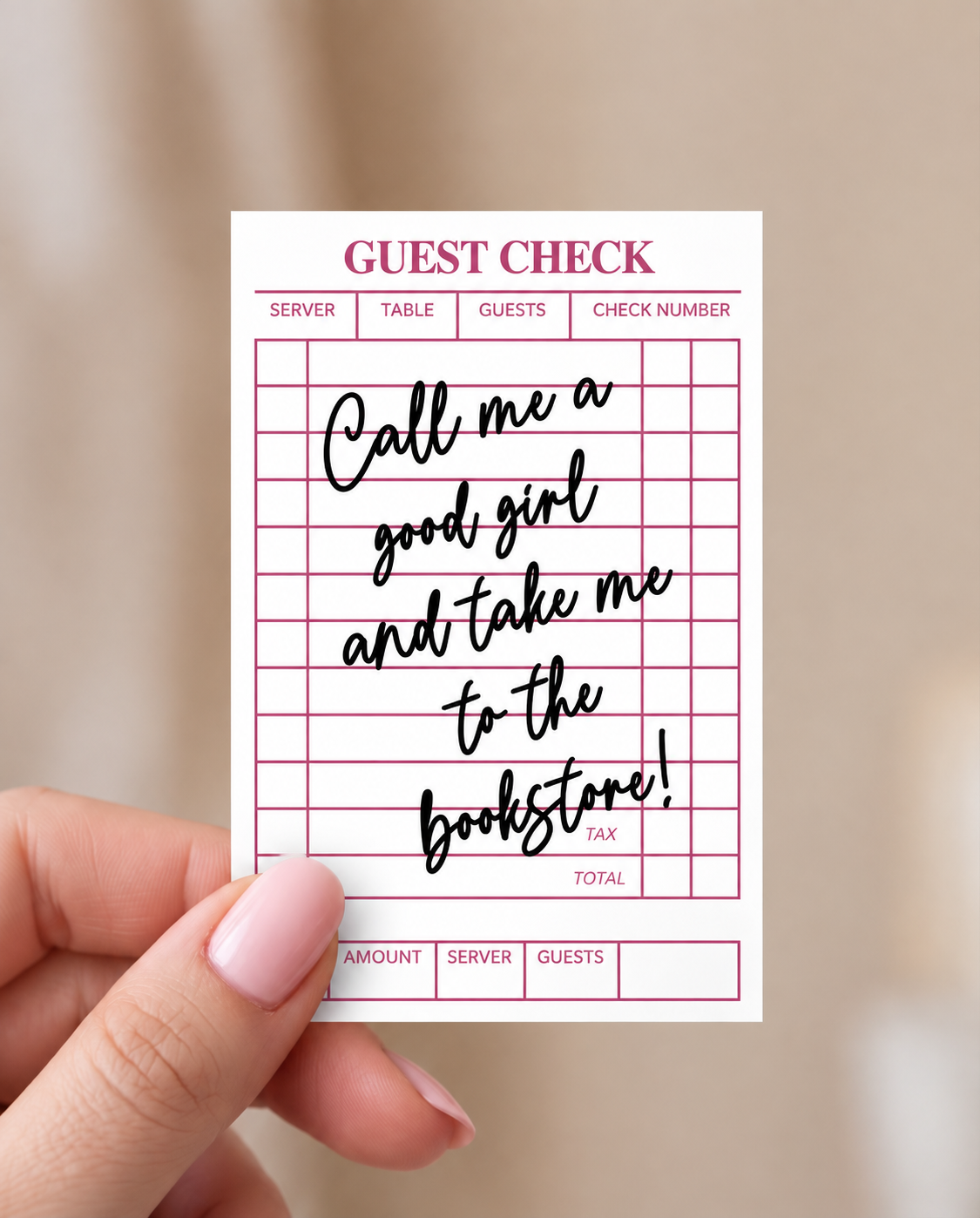 A hand with pink manicured nails holds a novelty guest check card that reads 'Call me a good girl and take me to the bookstore!' in black script on a white background with magenta grid lines and text.