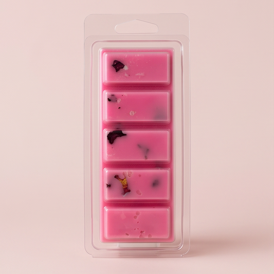 Pink wax melts in a packaging tray on a pink background