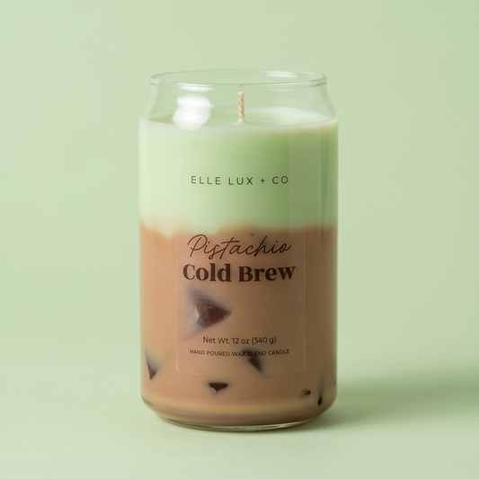 Candle in a glass jar labeled 'Pistachio Cold Brew' by Elle Lux & Co on a light green background